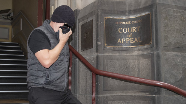 David Hingst covers his face as he leaves the Court of Appeal in Melbourne on Friday.