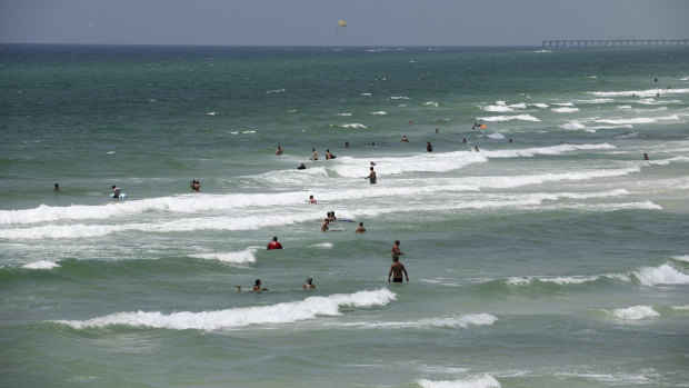 People swim at a beach in Panama City, Florida, US.