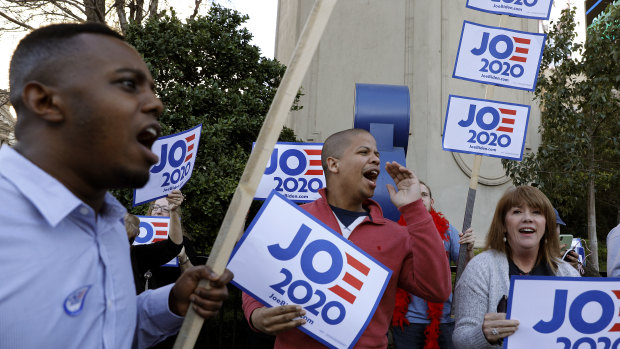 People cheer and hold signs in support of Joe Biden in Las Vegas, Nevada.