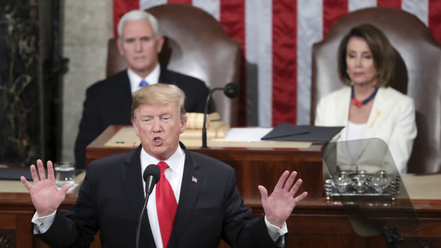 US President Donald Trump gives his State of the Union address as Vice-President Mike Pence and Speaker of the House Nancy Pelosi look on.