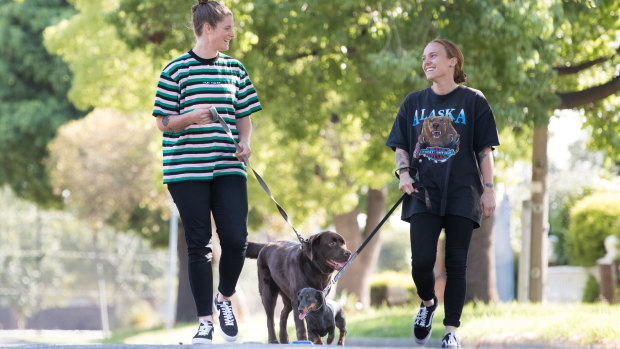 Blues skipper Bri Davey and partner and teammate Tilly Lucas-Rodd walk their dogs, Pikelet and Bonnie.
