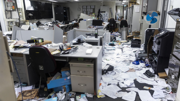 Paper and damaged furnishings sit in the security control room during a media tour of the Legislative Council building in Hong Kong.
