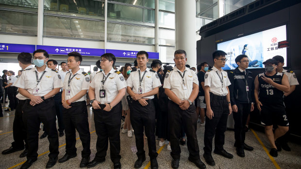 Airport security staff stand guard at the Hong Kong International Airport on Wednesday evening.