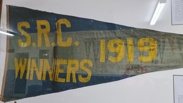 The framed 1919 pennant flag at the Sandringham Rifle Club.