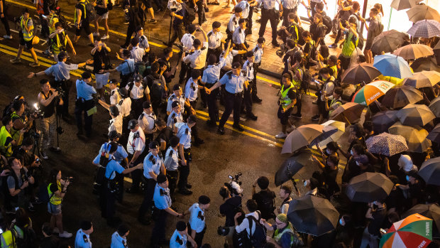 Demonstrators clash with police on Canton Road during a protest in the Tsim Sha Tsui district of Hong Kong on Sunday.