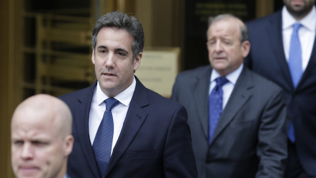 Michael Cohen, second from left, leaves court in New York in May.