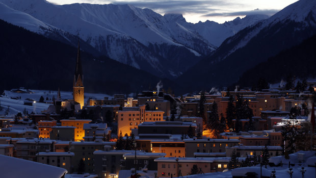 Buildings stand illuminated as dusk falls in Davos, the venue for the World Economic Forum (WEF), in Switzerland.