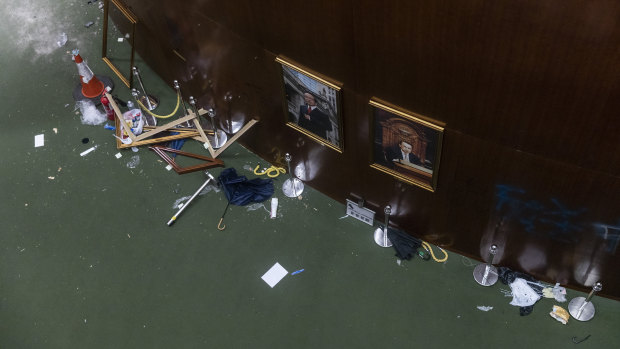 A broken politician portrait frame rests on the floor inside the Legislative Council building in Hong Kong.