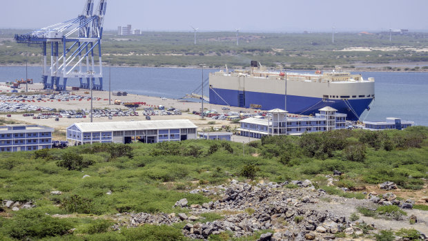 The Grand Aurora vehicle carrier, right, sits moored at Hambantota Port, operated by China Merchants Group, in Sri Lanka.