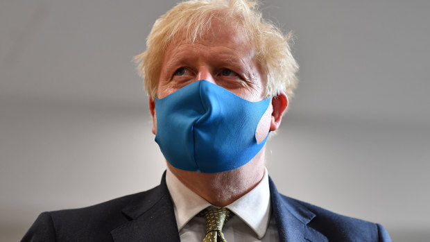 Prime Minister Boris Johnson wears a face mask during a visit to an ambulance station on Monday.