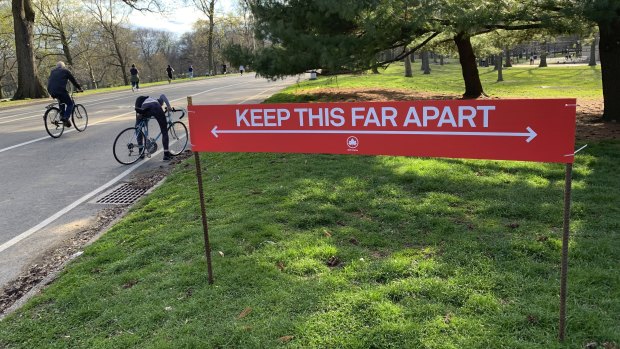 Signage urging social distancing is seen in Prospect Park in the Brooklyn borough of New York.
