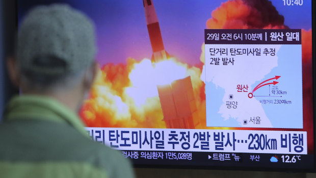 A man watches a TV screen in Seoul showing a file image of North Korea's missile launch.