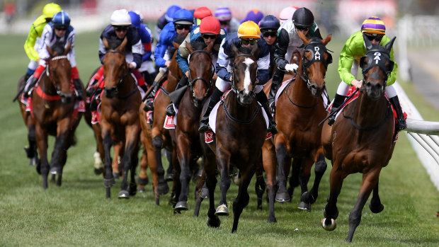 Race leaders Cismonte (right), Boomtime (second right) and Gallante (centre) on the first lap of the 2017 Melbourne Cup. 