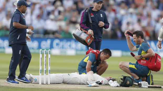 Steve Smith receiving treatment as he lies on the ground after being hit on the head by a ball bowled by England's Jofra Archer.