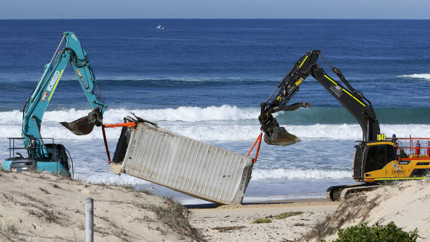 One of the shipping containers is salvaged from Birdie Beach on the Central Coast of NSW on Thursday.