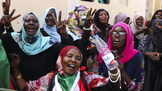Sudanese pro-democracy supporters celebrate a final power-sharing agreement with the ruling military council on Saturday.