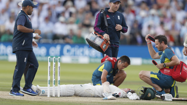 Steve Smith receiving treatment as he lies on the ground after being hit on the head by a ball bowled by England's Jofra Archer.