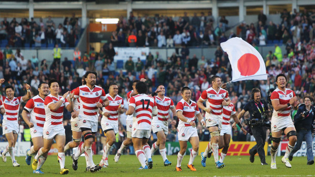 Four more years, two more scalps: Japan in 2015 celebrating the first of their big World Cup upsets. 