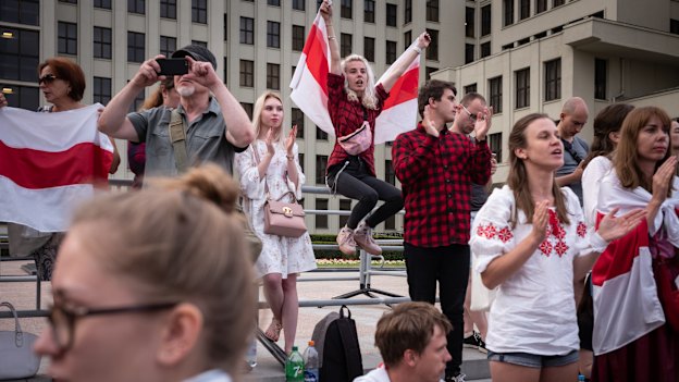 Protesters wave the traditional Belarusian flag on August 18 in Minsk. 