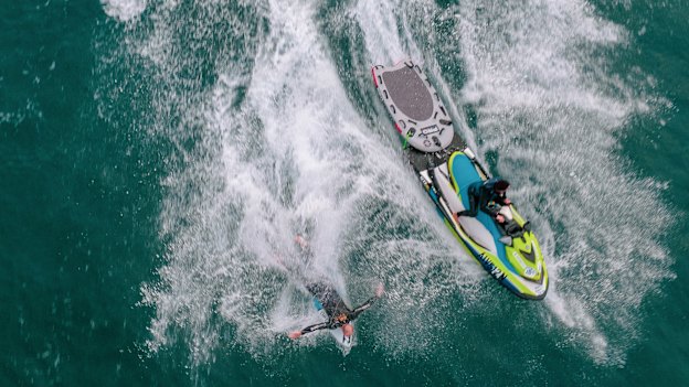 Formston gets ready  to pop up on a wave off Boulder Beach, launched by Michael Crisp from the jet ski. 