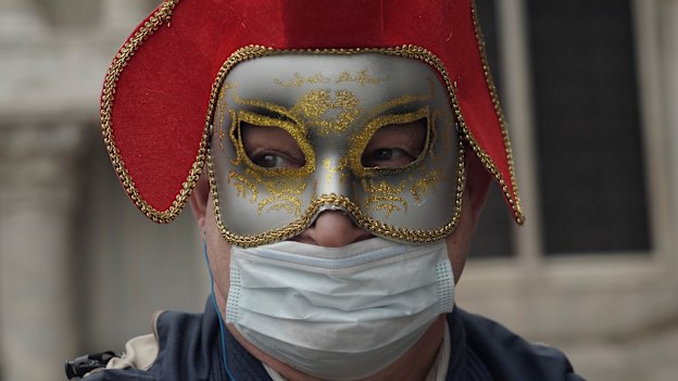 A Russian tourist dons a carnival mask and protective mask for Carnival. The event was cancelled two days before it was due to finish. 