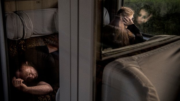 Passengers nap to while away the time.