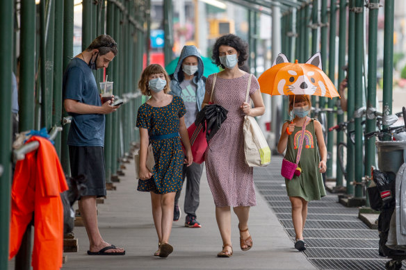 A family in New York City wearing masks. 