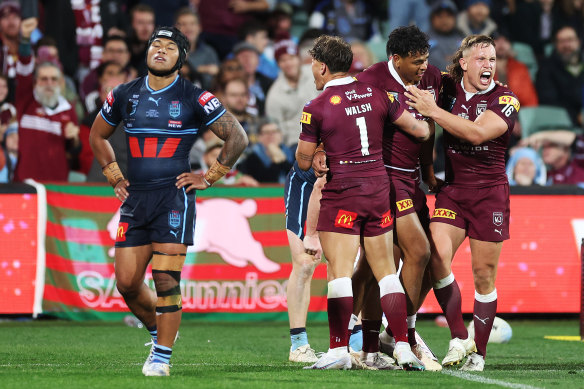 Selwyn Cobbo celebrates a try with his Maroons teammates.