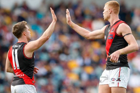 Peter Wright (right) booted five goals in Essendon’s win.