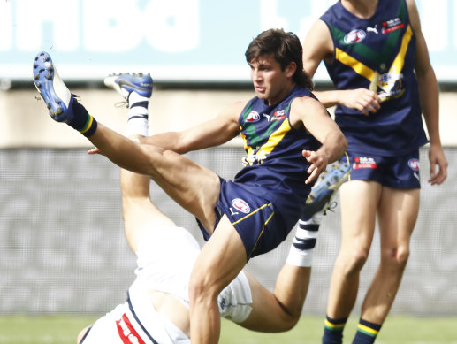 Draft prospect Josh Rachele kicks over his head, soccer style.