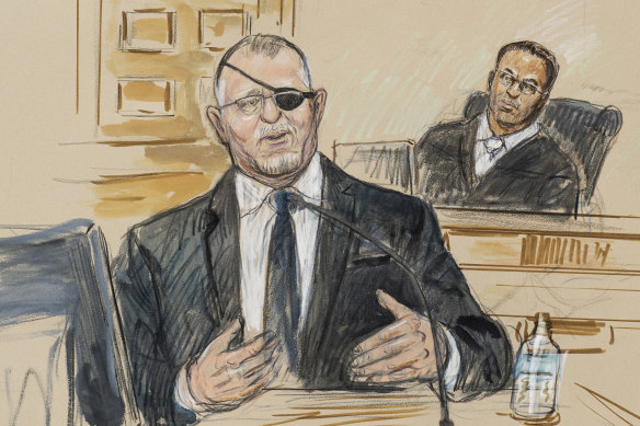 This artist sketch depicts the trial of Oath Keepers leader Stewart Rhodes, left, as he testifies before US District Judge Amit Mehta.