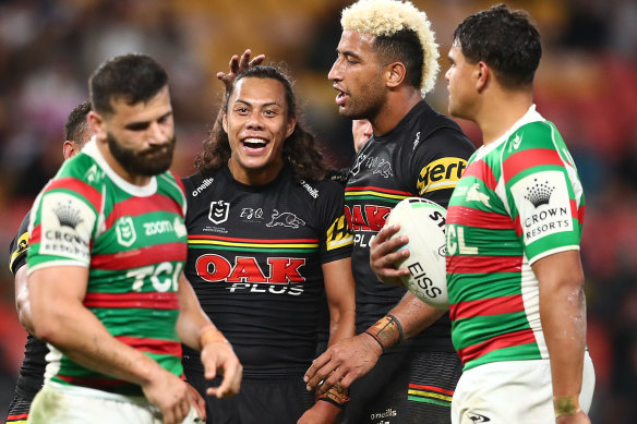 Panthers five-eighth Jarome Luai celebrates a handling error by former teammate Josh Mansour (left).