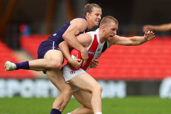 St Kilda's Seb Ross is wrapped up by Docker Nat Fyfe on Saturday.