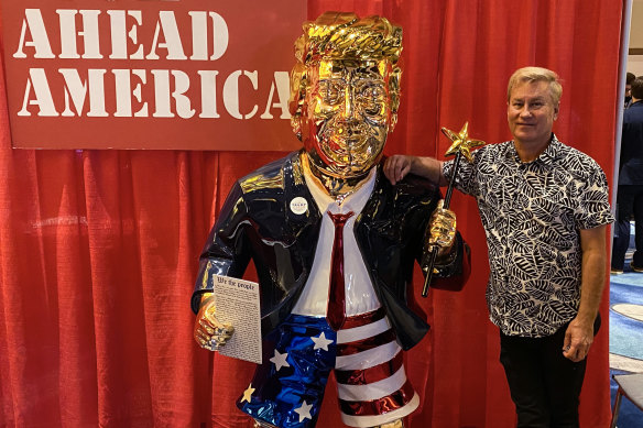 Tommy Zegan with his golden Donald Trump statue at the Conservative Political Action Conference in Orlando.