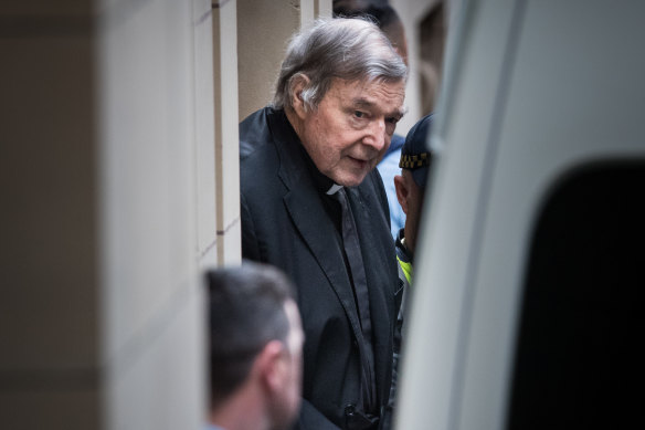 George Pell leaving Melbourne's Supreme Court building in handcuffs in August.