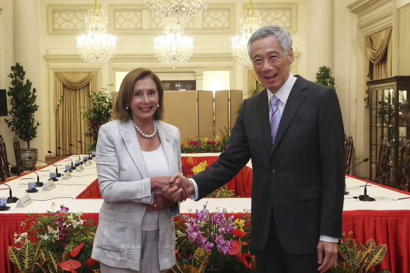 US House Speaker Nancy Pelosi, left, and Singaporean Prime Minister Lee Hsien Loong shake hands at the Istana Presidential Palace in Singapore. Pelosi arrived in Singapore early on Monday, kicking off her Asian tour.