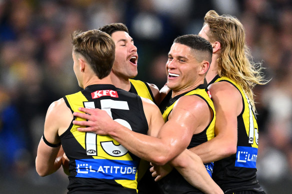 Dion Prestia celebrates a goal with his teammates.