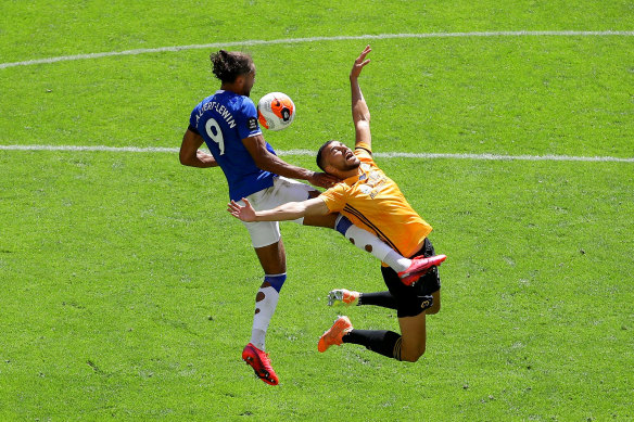 Everton's Dominic Calvert-Lewin and Romain Saiss for Wolves challenge for the ball