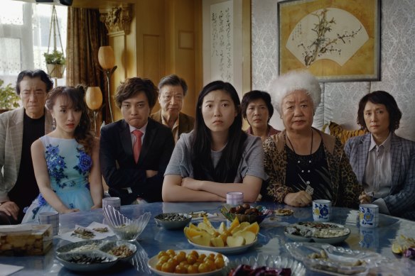 Awkwafina (centre) plays a woman railing against a family lie in Lulu Wang’s breakthrough, The Farewell.