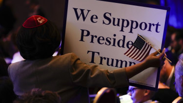 An attendee holds a sign during the Republican Jewish Coalitions National Leadership Meeting in Las Vegas, Nevada.