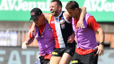 Hard yards: St Kilda's Jarryn Geary suffered a serious blow during the match in Shanghai.