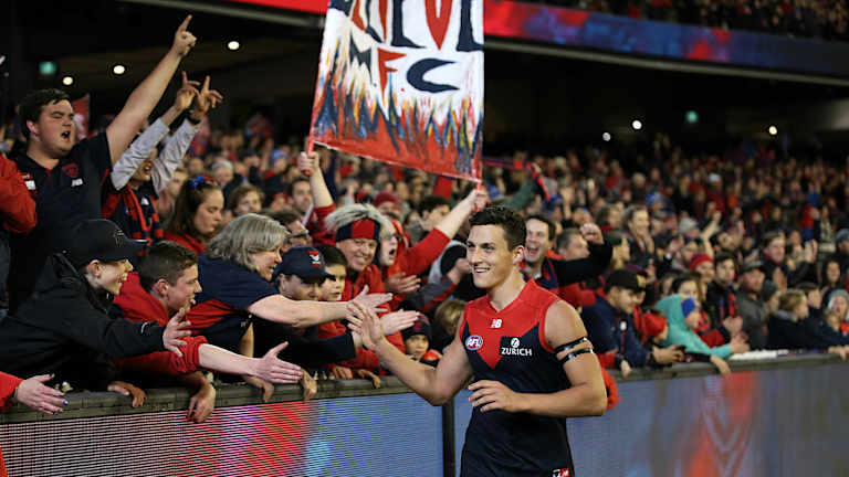 Keeping the dream alive: Sam Weideman celebrates with the red and blue faithful after Melbourne's win over Geelong.