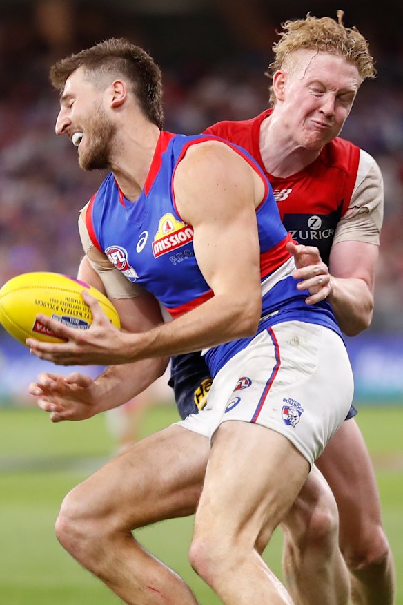 Clayton Oliver tackles Marcus Bontempelli.