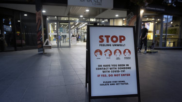 A health notice is displayed at the entrance to a shopping center in the Brunswick suburb of Melbourne.