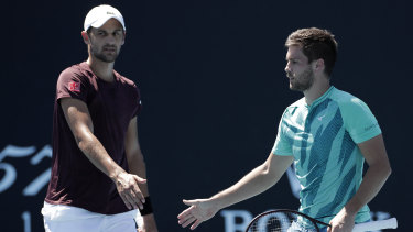 Nikola Mektic and Mate Pavic talk tactics in their first-round doubles win during day four of the 2022 Australian Open at Melbourne Park.