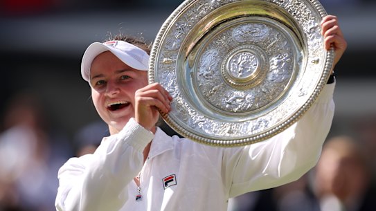 Barbora Krejcikova of Czechia lifts the trophy following victory against Jasmine Paolini of Italy.