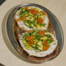 Smoked trout quark, pickled zucchini and salmon roe tartine bagel.