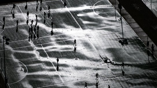 Drizzling and dribbling: school kids in Dee Why, Sydney, play on wet netball and basketball courts on Friday.