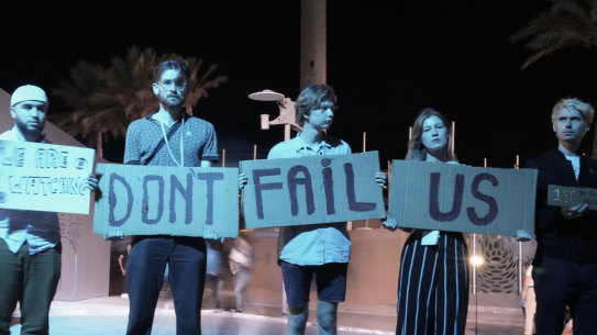 Activists hold signs at the COP27 UN Climate Summit on Saturday in Sharm el-Sheikh, Egypt. 