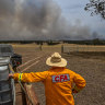 Farmer and CFA volunteer Tim Gubbins monitors the fire next to his property near Moyston.